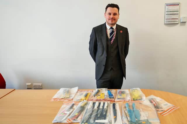 Cllr Joshua Roberts with some of the knives seized during Sceptre.