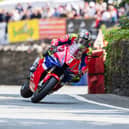 John McGuinness races around the Isle of Man in practice