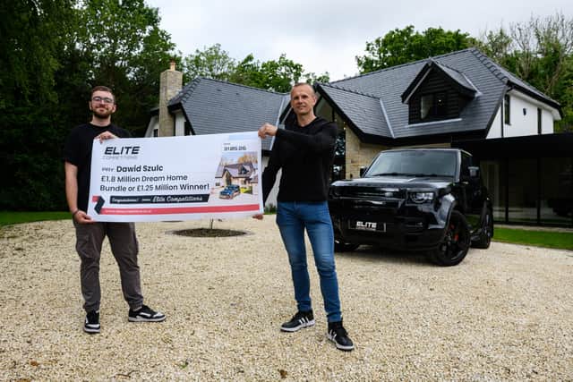 Dawid Szulc with Luke Morgan from Elite Competitions with a cheque outside the Penwortham house and car which he has won. Photo: Kelvin Lister-Stuttard
