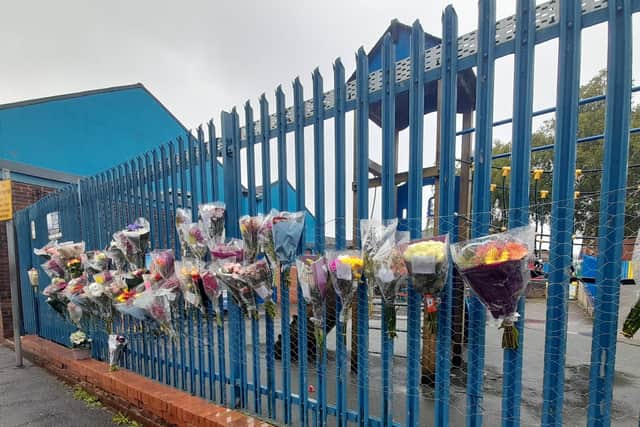 Floral bouquets line the railings outside St Joseph’s Primary School in Rigby Street as staff, parents and pupils pay tribute to Lyn Rochford, who recently passed away