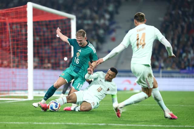 Kylian Mbappe fights for the ball with Ali McCann