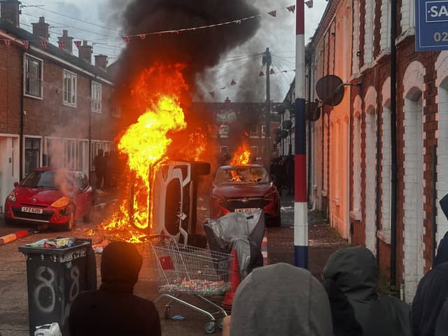 Vehicles set on fire by protesters on Lendrick Street in Belfast (PA)
