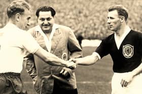 Tommy Docherty, right, shakes hands before a Scotland match. The former Preston North End midfielder was part of Scotland’s 1958 World Cup squad