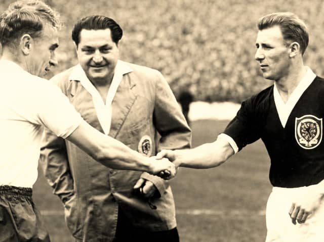 Tommy Docherty, right, shakes hands before a Scotland match. The former Preston North End midfielder was part of Scotland’s 1958 World Cup squad
