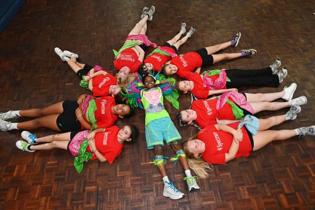 Cayden, 11, centre, surrounded by some of the members during the weekly practice at Spectrum Association, a carnival troupe based in Preston.
