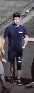 The man is described as white, around 30 years, light brown short hair, slim build, wearing a dark Nike baseball cap, navy/black Berghaus t-shirt, dark shorts, black knee brace on left knee, black Nike trainers with white soles.