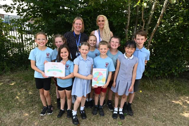 Headteacher Kate Penarski, right, and assistant headteacher Mrs Barlow, left, with pupils at Penwortham Primary School and their bronze myHappymind accreditation.