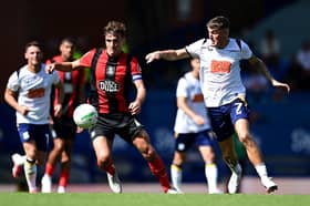 Preston North End's Alfie Devine vies for possession with Huddersfield Town's Ryan Ledson