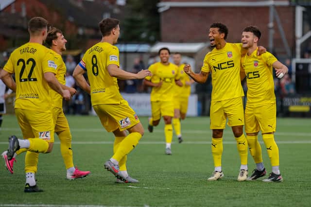 Callum Rowe, second from right, is mobbed after his goal against Marine