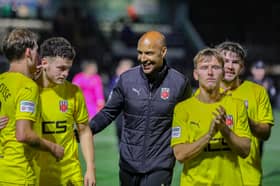 Chorley boss Andy Preece, centre, celebrates with his players at the end of the 2-0 win over Marine