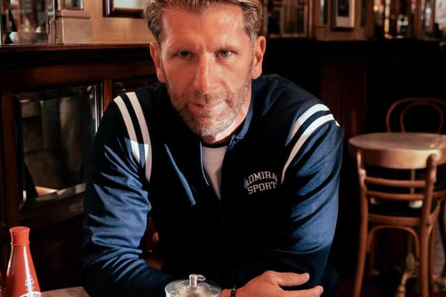 Richard Cresswell models a white and navy tracksuit, part of Admiral Sports’ PNE collection, at Brucciani’s.