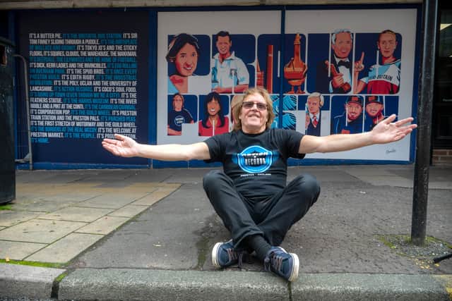 Gordon Gibson outside the Lune Street mural featuring Proud Prestonians - including himself