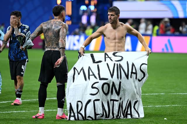 Argentina players unveil a banner at the end of their World Cup semi-final against England