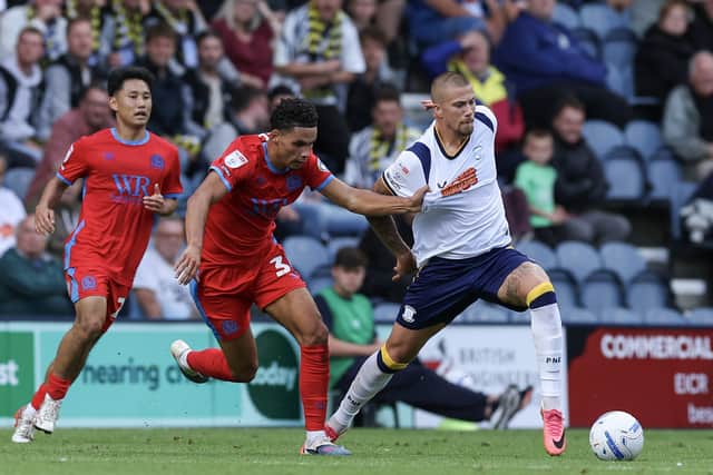Preston North End's Harry Clarke holds off the challenge from Blackburn Rovers' Kristi Montgomery
