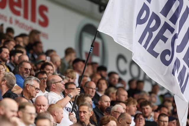 Preston North End fans watch their team in action 