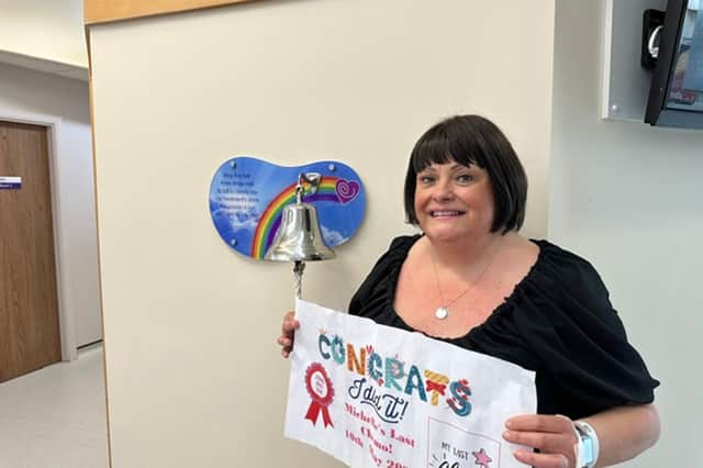 Michelle rings the bell to mark the end of her cancer treatment.