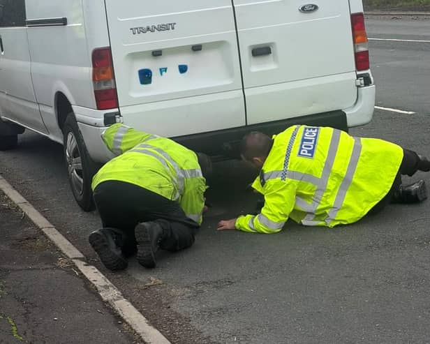 Police officers search a vehicle at one of the checkpoints.