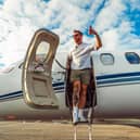 Rob stepping off the private jet when landing back in the UK