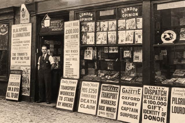 Newsagent John Slater outside his shop on Tulketh Road, Ashton, in 1926, with newspaper headlines and advertising boards competing for customers' attention
