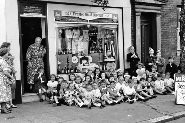 Children gather outside the Fearnley family's newsagent's and off-licence shop on London Road during the Preston Guild celebrations of 1952