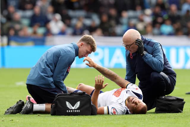 Preston North End's Harry Clarke receives treatment late i the first half after picking up an injury.
