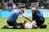 Preston North End's Harry Clarke receives treatment late i the first half after picking up an injury.