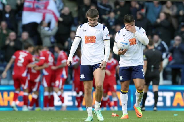 Preston North End's Alfie Devine (left) and Jusef Erabi are left dejected as Millwall players celebrate their opening goal scored by Camiel Neghli.