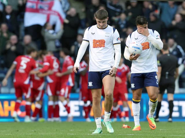 Preston North End's Alfie Devine (left) and Jusef Erabi are left dejected as Millwall players celebrate their opening goal scored by Camiel Neghli.