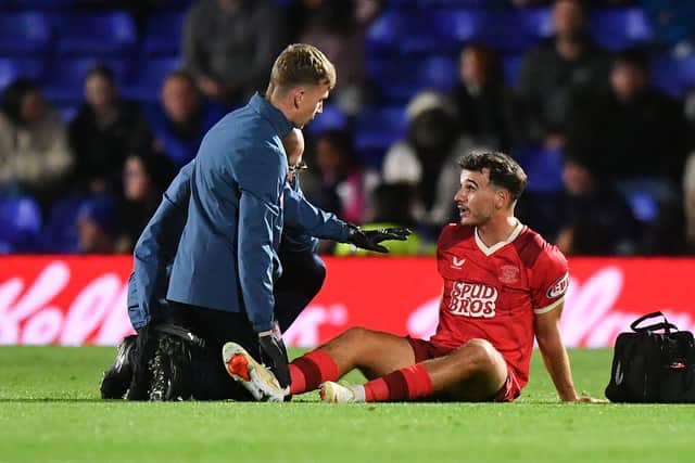 Preston North End's Liam Gibbs receives treatment
