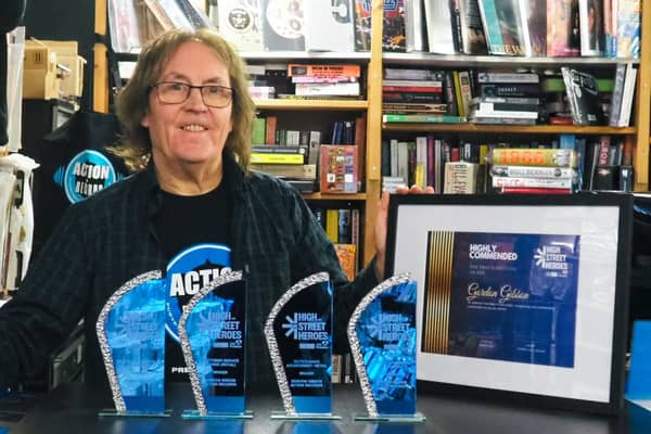 Gordon Gibson with his four trophies and certificate