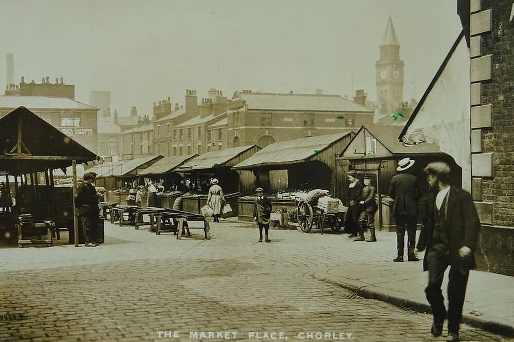 Chorley Market around 1905, showing the old market buildings, traders and shoppers in the town centre