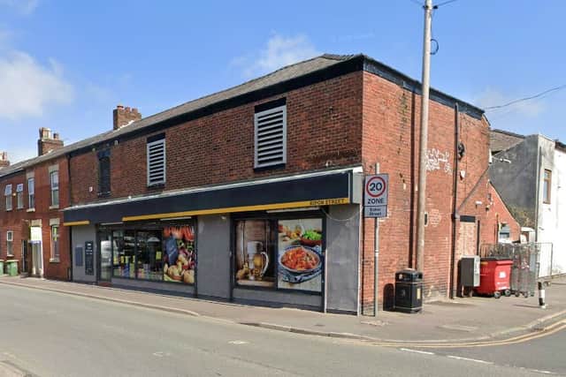 A parcel locker has been installed on the shop elevation to the right.