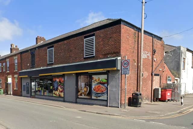 A parcel locker has been installed on the shop elevation to the right.