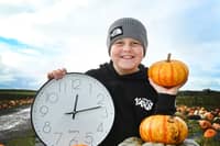 Ronnie, nine, having Halloween fun at The Pumpkin Patch at Bradshaw's Farm Shop and Garden Centre, Garstang, reminding readers clocks go back by one hour this Sunday at 2am, shifting from British Summer Time to Greenwich Mean Time.  