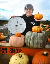Ronnie, nine, having Halloween fun at The Pumpkin Patch at Bradshaw's Farm Shop and Garden Centre, Garstang, reminding readers clocks go back by one hour this Sunday at 2am, shifting from British Summer Time to Greenwich Mean Time.  