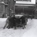 A winter wonderland – but not for motorists! A car is pushed through the snow on Preston’s Flag Market in 1981, as our nostalgic photo series revisits the people, places and memorable moments of the Eighties  
