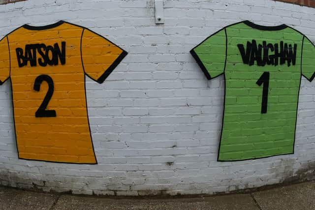 A painted Cambridge United shirt to honour Brendon Batson and John Vaughan are seen on a wall at the Abbey Stadium.