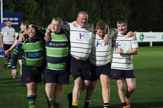 Bruce (third left), whose Assassins team won, leaves the field supported by players from both sides