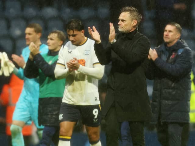 Preston North End manager Graham Alexander  applauds the fans at the final whistle.