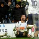 Preston North End's Andrew Hughes (grounded) is mobbed by team-mates as he celebrates scoring the opening goal 