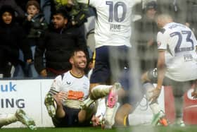 Preston North End's Andrew Hughes (grounded) is mobbed by team-mates as he celebrates scoring the opening goal 