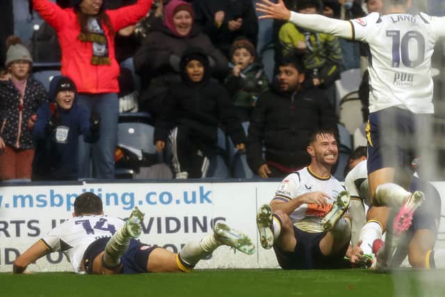 Preston North End's Andrew Hughes (grounded) is mobbed by team-mates as he celebrates scoring the opening goal 