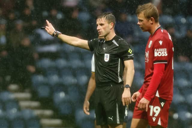 Referee Elliot Bell gestures