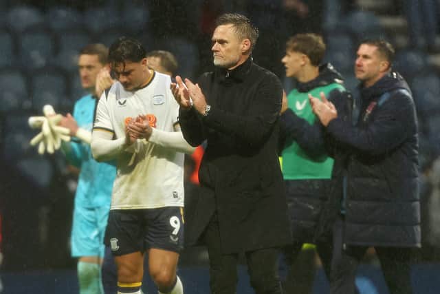 Preston North End manager Graham Alexander joins his players as they applaud the fans at the final whistle
