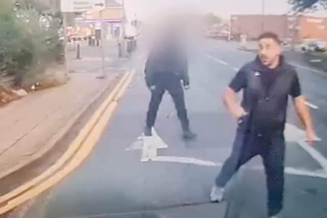Still from dash cam footage depicts Hawkar Karimi embroiled in a fist fight with another road user.