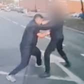 Still from dash cam footage depicts Hawkar Karimi embroiled in a fist fight with another road user. 