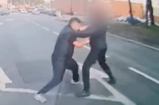 Still from dash cam footage depicts Hawkar Karimi embroiled in a fist fight with another road user.