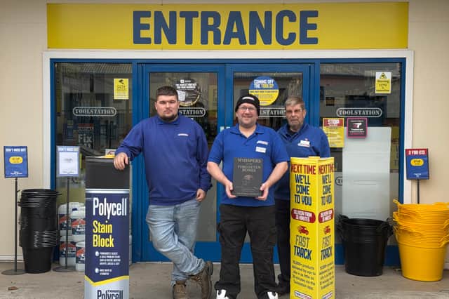 Ian with his first book and two of his colleagues outside Toolstation in Bamber Bridge
