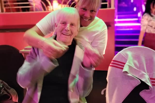 A resident and team member dancing together