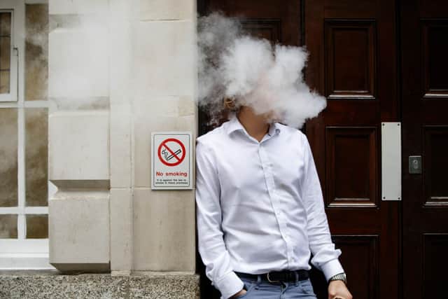 A smoker is engulfed by vapours as he smokes an electronic vaping machine (TOLGA AKMEN/AFP via Getty Images)